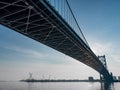 Large Bridge over a River with a Blue Morning Sky - Underneath a Bridge