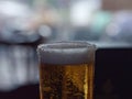 Detail of the rim of the iced glass containing beer.