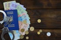 A photograph of a Ukrainian foreign passport, a certain amount of Ukrainian money and police handcuffs. The concept of arresting