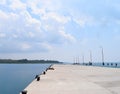 Uncrowded Ferry Jetty with Open Sea and Cloudy Sky Royalty Free Stock Photo