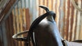 A very old saddle horn with a bridle hanging on it. Royalty Free Stock Photo