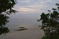 Through Window of Nature - View of Peaceful and Uncrowded White Sandy Beach from Gap between Trees Royalty Free Stock Photo