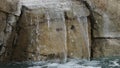 A water fall in a pool.