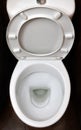 A photograph of a white ceramic toilet bowl in the dressing room or bathroom. Ceramic sanitary ware for correction of nee