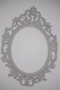 Photograph of white rococo frame hanging on wall