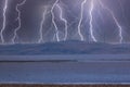 Photograph of Wind Turbines on a hill during a lightning storm Royalty Free Stock Photo