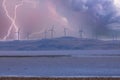 Photograph of Wind Turbines on a hill during a lightning storm Royalty Free Stock Photo