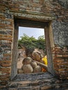 A Photograph of window view of statue of Reclining Buddha