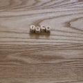 Wooden letters spelling June on a wooden background