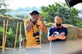 Photographer Alexandre Magno adjusting his goggles and deputy Gil Diniz at the Taubatexas stand