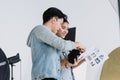 An Asian photographer is introducing poses to young Asian models. By opening preview of posting in the document