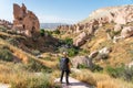 A photographer with backpack looking to Zelve open air museum in Capadocia plateau, central Anatolia, Turkey Royalty Free Stock Photo