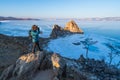 A Photographer with backpack taking picture of Baikal frozen lake in a morning, Olkhon island, Siberia, Russia Royalty Free Stock Photo