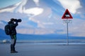 Photographer with big lens and road traffic sign with Polar bear. Ã¯Â¿Â½Gjelder Hele Svalbard means Over All of Svalbard watch out f Royalty Free Stock Photo