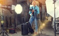 Photographer with camera among photo equipment Royalty Free Stock Photo