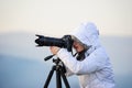photographer with camera and tripod outdoor taking landscape picture Royalty Free Stock Photo