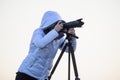 photographer with camera and tripod outdoor taking landscape picture Royalty Free Stock Photo