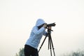 photographer with camera and tripod outdoor taking landscape picture Royalty Free Stock Photo