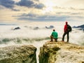 Photographer check weather condition. Freelancer with camera on cliff