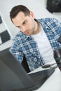 Photographer checking photos in camera at desk in office Royalty Free Stock Photo