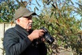 Photographer checking settings on the screen of a camera. Royalty Free Stock Photo