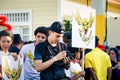Photographer checks photos at his camera on city street at dominican carnival