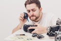 Photographer cleaning camera with vacuum pump. hand blower dust