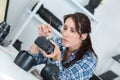 Photographer cleans front lens on camera