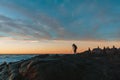 Photographer on Cliff and Beautiful Sunset in Mexican beach.