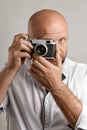 Photographer. Close up portrait of man holding vintage camera