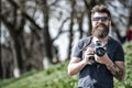 Photographer concept. Man bearded hipster photographer hold vintage camera. Photographer with beard and mustache amateur