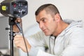 photographer controlling studio flash strobe lighting head Royalty Free Stock Photo