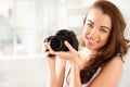 Photographer, digital camera and photography with a woman taking a photograph or picture inside. Portrait of a young Royalty Free Stock Photo