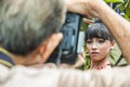 A Photographer and a female model doing a photo shoot.