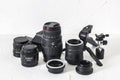 Photographer equipment: lenses, tripods, adapters, macro rings, macro rails on a white background.