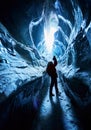 Photographer exploring an amazing glacial ice cave Royalty Free Stock Photo