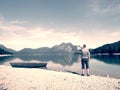 Photographer with eye at viewfinder is taking photo of lake with Alps Royalty Free Stock Photo