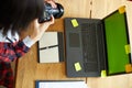 Photographer female working in a creative office holding camera, at desk and retouch photo