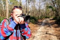 Photographer in the forest photographing the natural environment Royalty Free Stock Photo