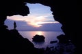 Photographer in front of the cave near the sea with kayaking. Royalty Free Stock Photo