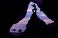 Photographer in front of the cave near the sea. Royalty Free Stock Photo