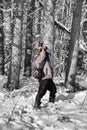 Photographer in a ghostly forest photographs something on a tree