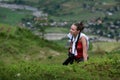 Photographer girl climbs a mountain