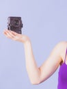 Female hand with camera on blue Royalty Free Stock Photo