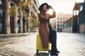 Photographer in glasses take photo on retro camera. Tourist portrait. Girl in hat travels in Barcelona holiday. Sunlight flare Royalty Free Stock Photo