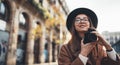 Photographer in glasses take photo on retro camera. Tourist portrait girl in hat travels in Barcelona holiday. Sunlight flare Royalty Free Stock Photo