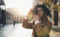 Photographer in glasses take photo on retro camera. Tourist portrait. Girl in hat travels in Barcelona holiday. Sunlight flare Royalty Free Stock Photo