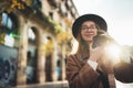 Photographer in glasses take photo on retro camera. Tourist portrait. Girl in hat travels in sun day Barcelona holiday. Sunlight Royalty Free Stock Photo