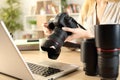 Photographer hands with laptop checking camera Royalty Free Stock Photo