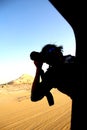 Photographer hanging off car Window taking shot